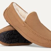 Pair of brown loafers with black soles on a white background