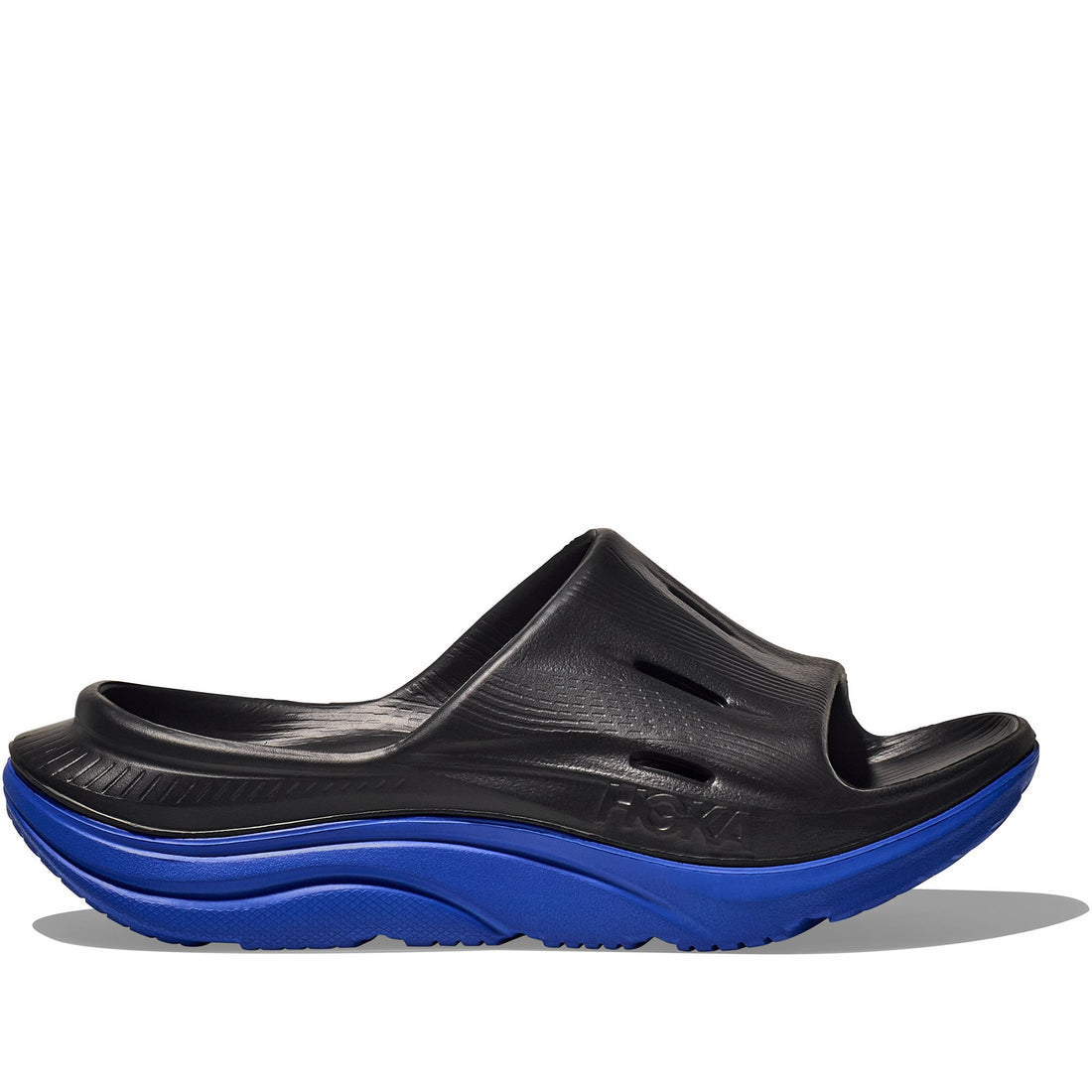 Quarter turn view Unisex Hoka Footwear style name Ora Recovery Slide 3 in color Black/ Ultramarine. Sku: 1135061-BLTR