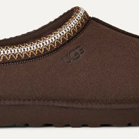 Brown slipper with a decorative trim on a white background