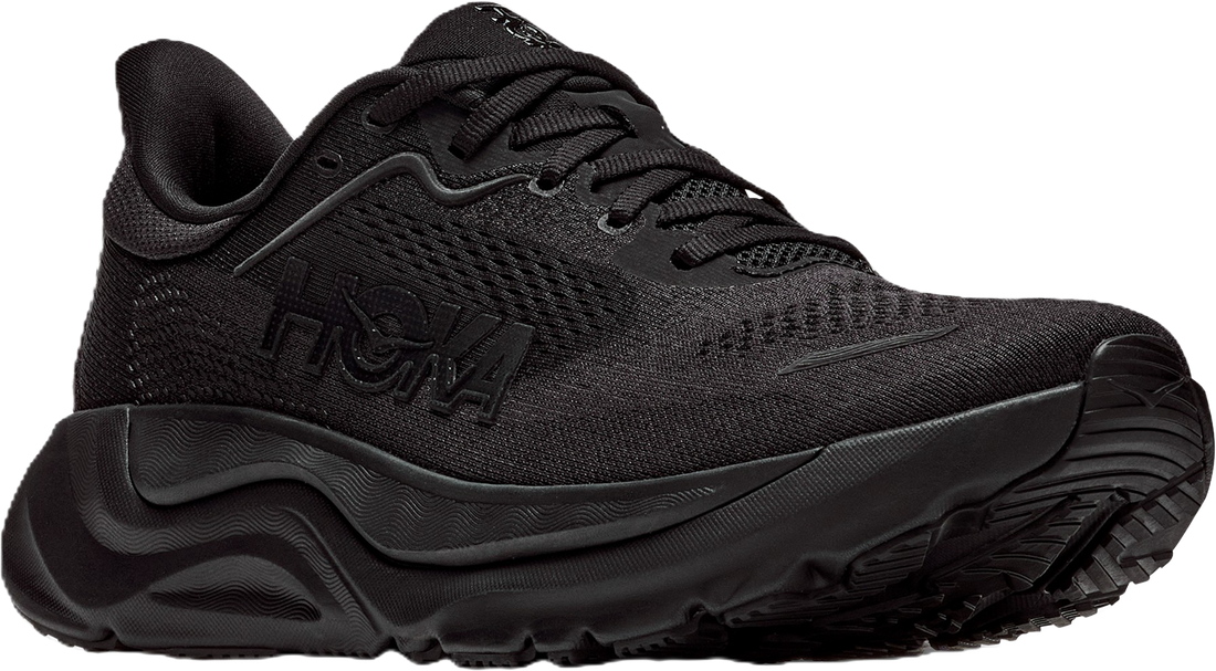 A black Hoka trail running shoe with a textured mesh upper, black laces, and a chunky black midsole and outsole, shown from a three-quarters angle on a white background.