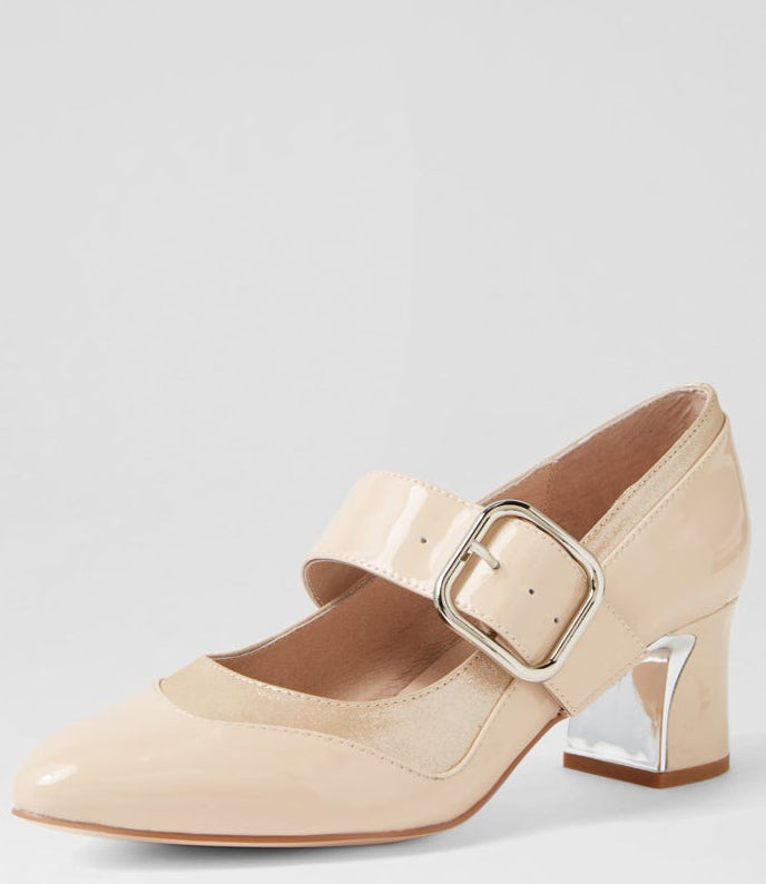 Beige shoe with a gold buckle on a light gray background