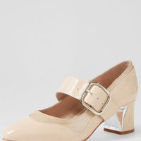 Beige shoe with a gold buckle on a light gray background