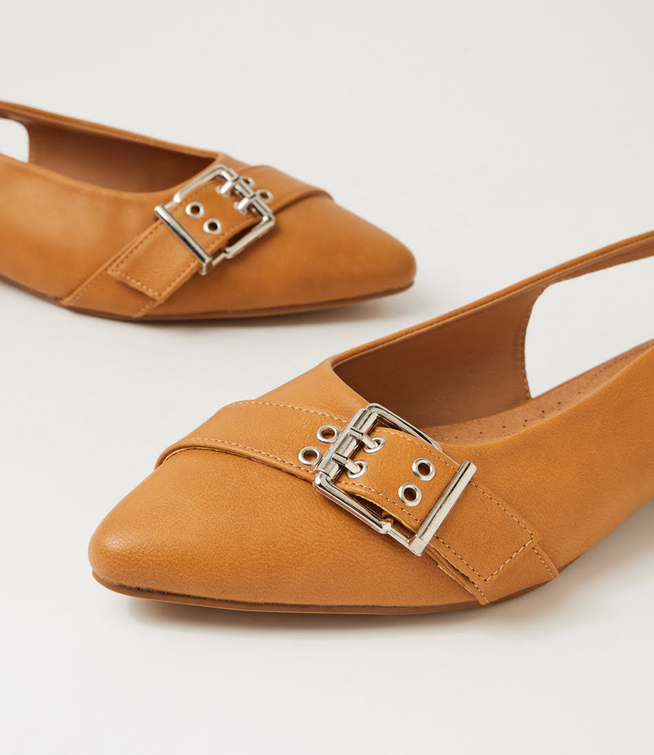A pair of tan leather pointed-toe flats with silver-tone buckle straps, shown on a clean white background.