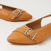 A pair of tan leather pointed-toe flats with silver-tone buckle straps, shown on a clean white background.
