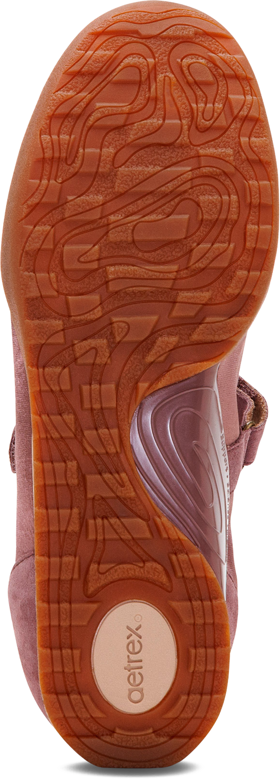 Close-up of the textured orange-brown sole of a pink shoe, showing the &