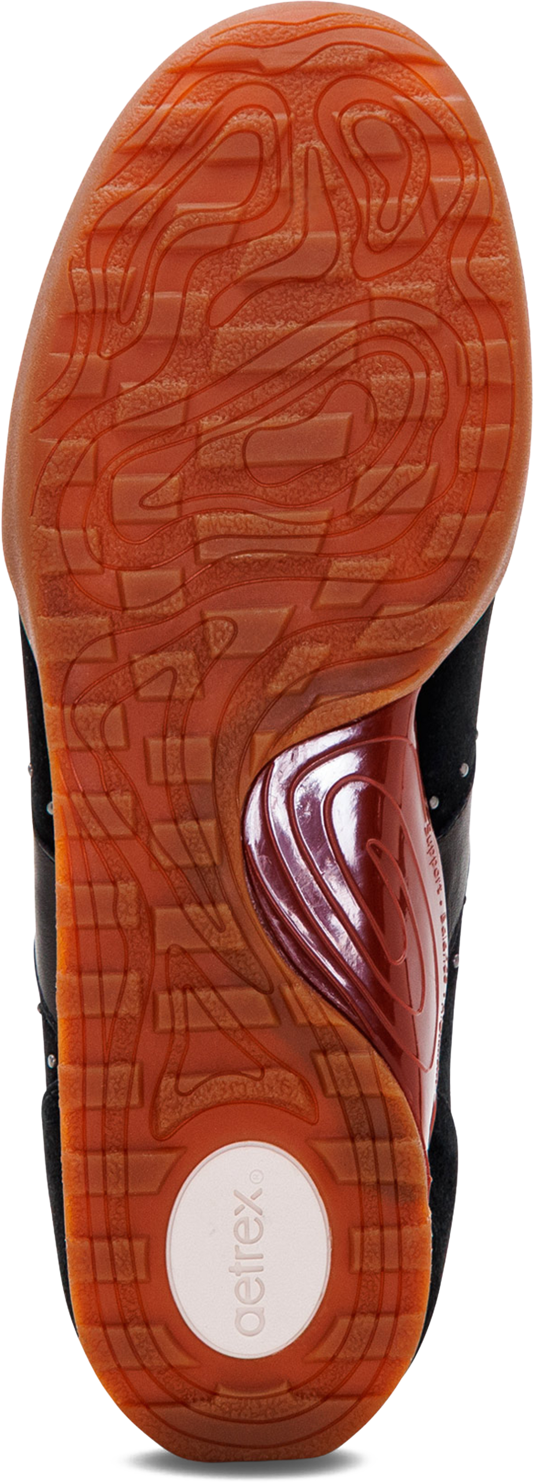 Close-up of the outsole of a sneaker, showing a textured orange-brown tread with a circular white heel area printed with the brand name &