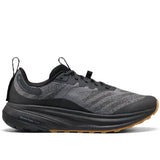 Black running shoe with brown sole on a white background